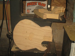 JX guitar body being cut